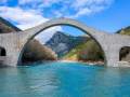 Arched stone bridge on a river