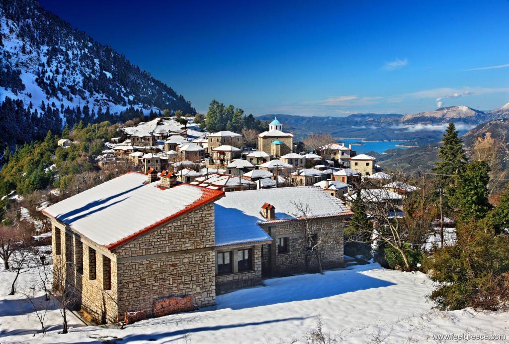 Rooftops of stone houses covered with snow