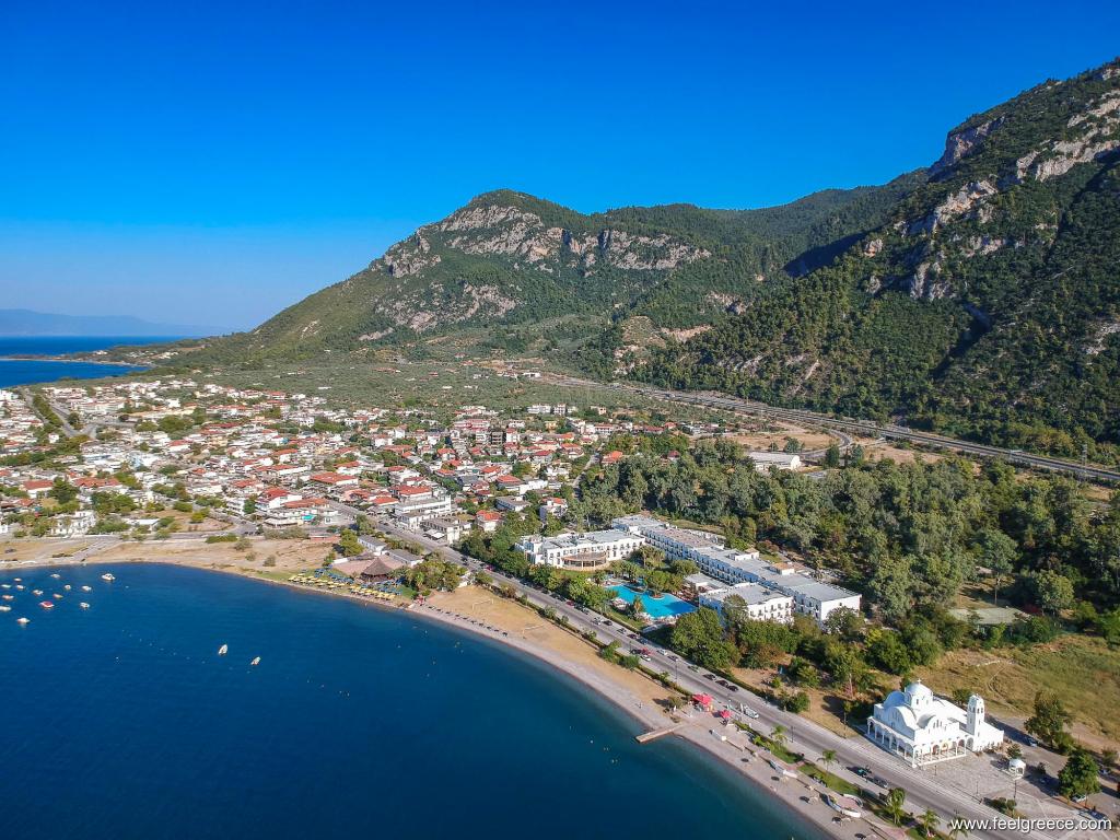 Aerial view of the village, the beach and the high hills behind