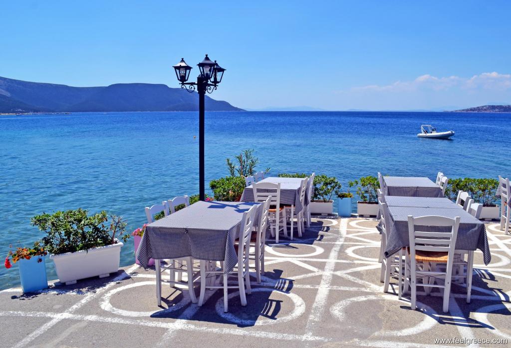 Tables and chairs of a taverna by the sea