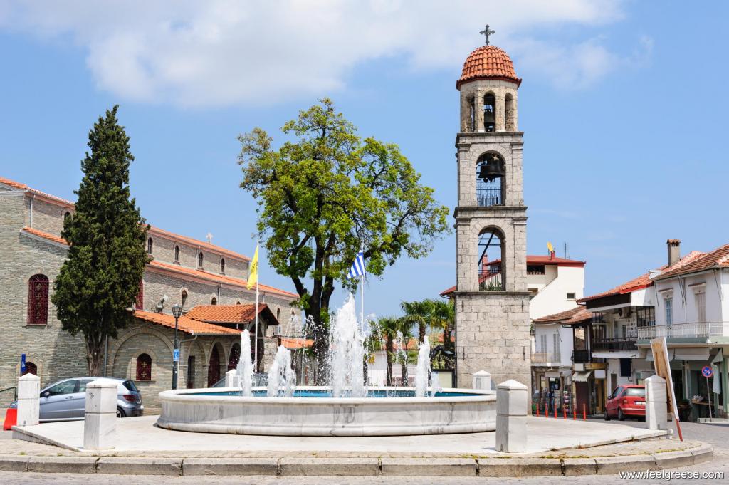 The central village square with a church and fountain