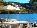 Beach taverna with white chairs and tables