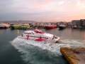 SeaJet speed boat maneuvers next to a port pier