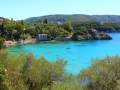 People swimming in the blue water around Platakia