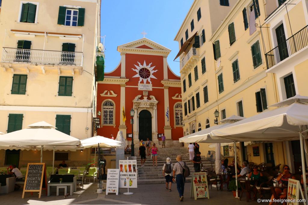 Red-painted church and a square with Venetian-style buildings