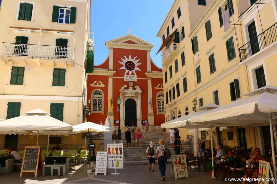 Red-painted church and a square with Venetian-style buildings