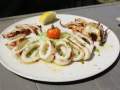 Big white plate with grilled squid